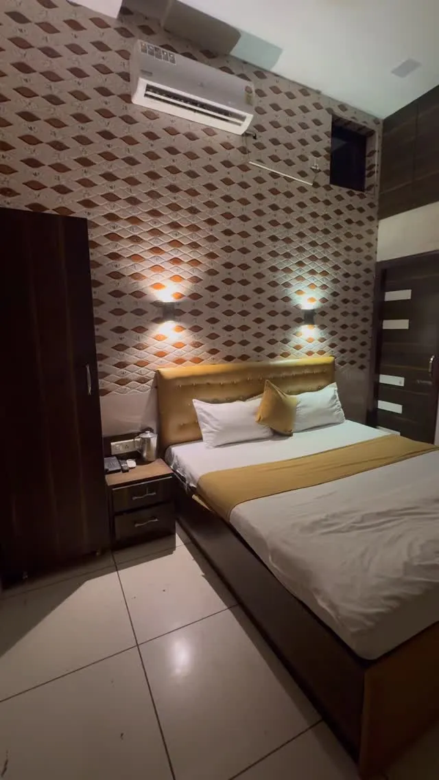 Hotel Max bedroom with gold bedding accents and patterned walls
