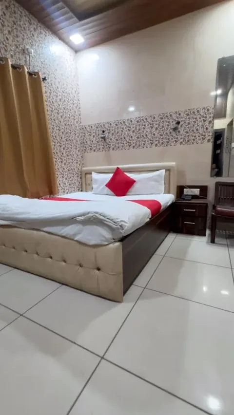 Hotel Max bedroom with red cushions, tiled walls and a wooden ceiling